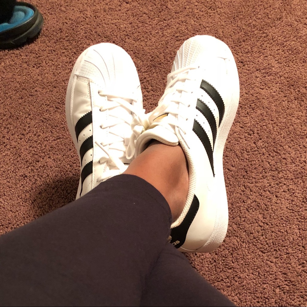 Adidas tennis with black stripes